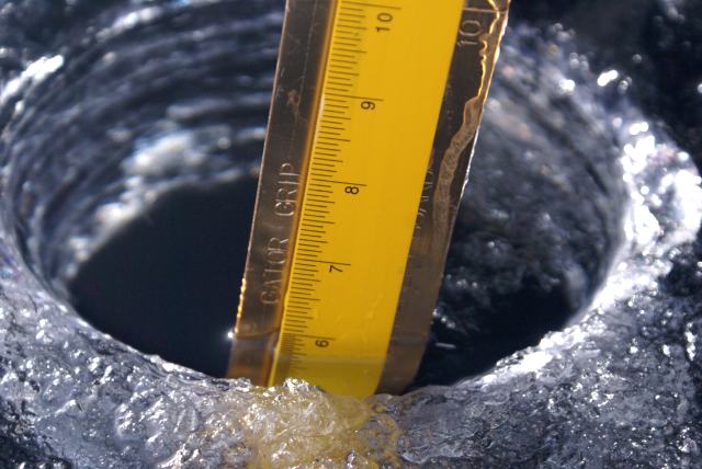 About 6 inches of very clear, dark ice.  There was only about 2 inches of powdery snow covering the ice.