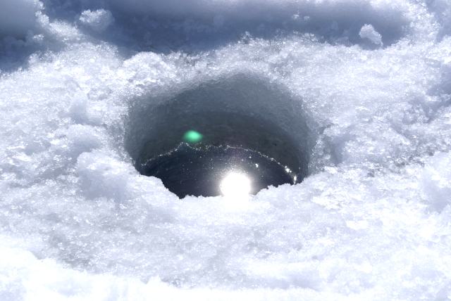 On Saturday morning, after some successful electricial work, a hole was punched into the covering of the lake to check the quality and quantity of the ice.