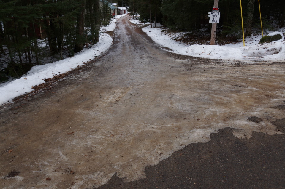 By the end of the week, warmer weather followed by freezing temperatures turned the snow on the lake and Knott Lane to ice.  White-ish and clear on the lake, brown and stone pocked on Knott Lane, it was all dangerously slippery and made foot travel difficult.