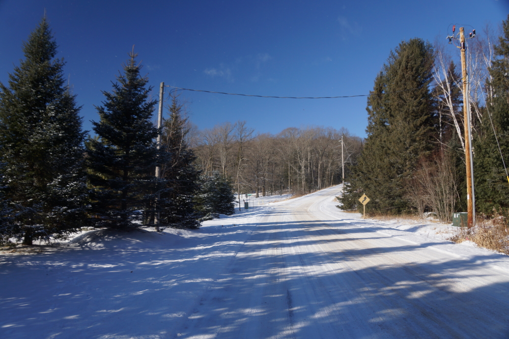 Local roads are covered with a packed layer of snow. Walking isn't too bad, no running though.
