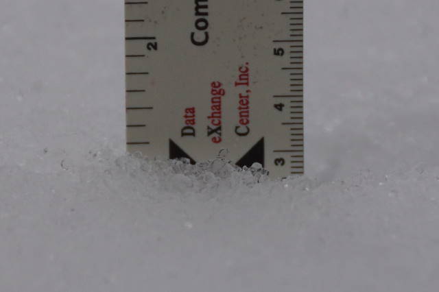 The inch of snow that covered decks and lawns Monday morning had a hard icy shell.  