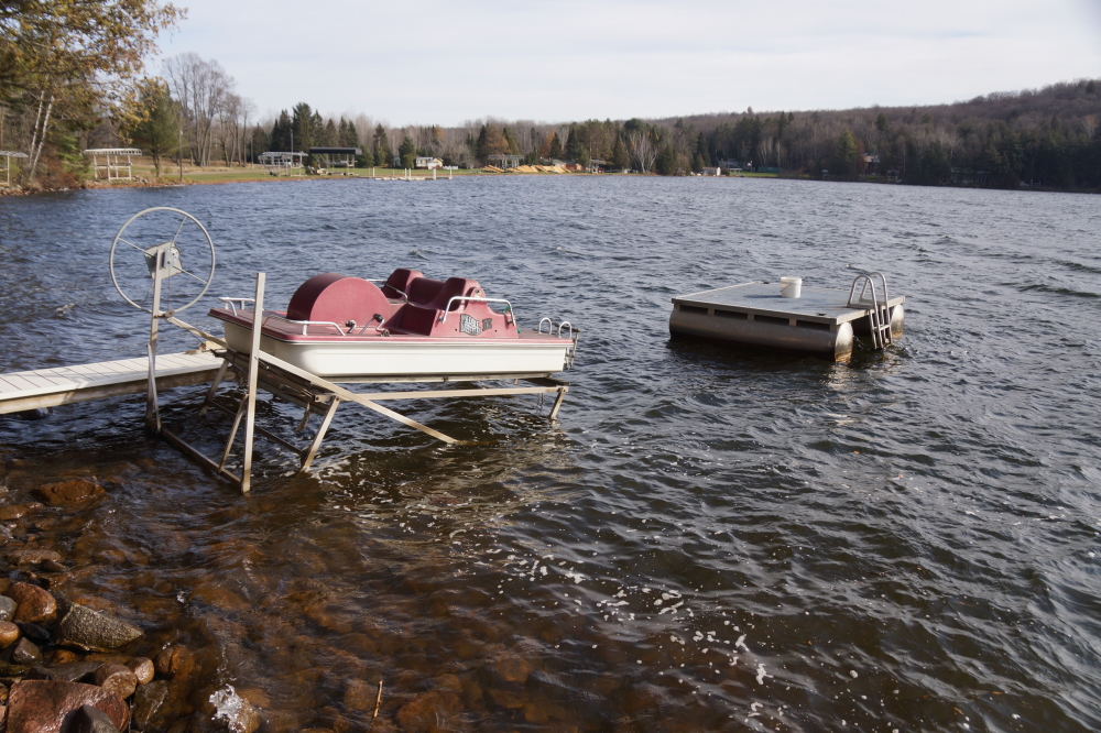Some lifts and boats still needed to be dragged to the shore before the ice has its way with them. The trick was to find people foolish enough to jump into the the 49°F water to yank the stuff out.
