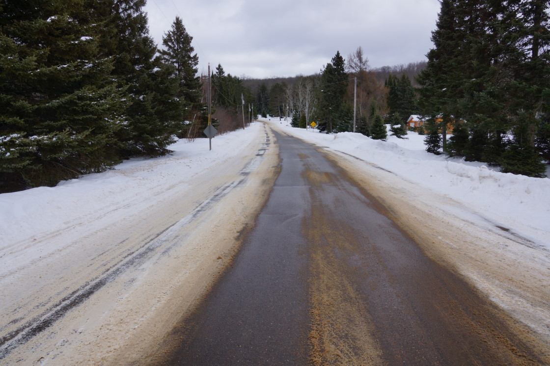 Thaw won the early round, as evidenced by the emerging road. It's been weeks since the Potawatomi Trail pavement has poked above the snow and ice. Coefficients of static friction went from close to zero to about five on local traction-o-meters.