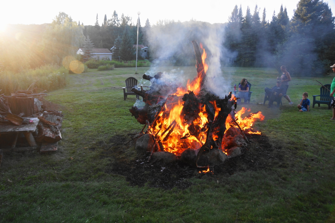 The air has a bit of a chill when the sun goes down. Campfires can remove that touch of cold. Ours included some large stumps.