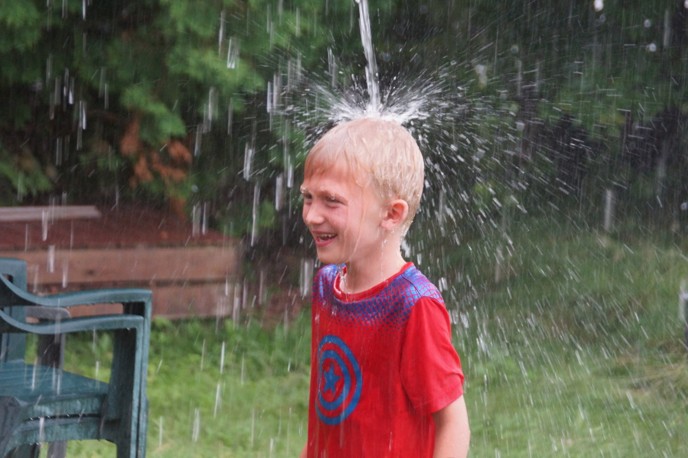 Much of the crowd fled the storm. A few braver, moister types embraced it.