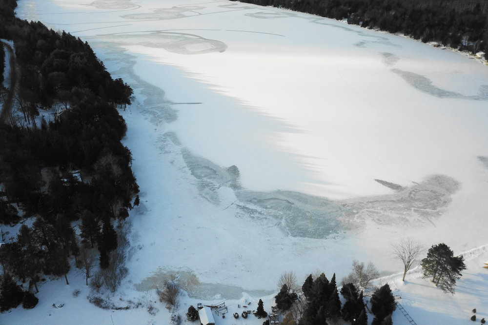 The warm passed, but not before forming puddles of water on the lake ice. By midweek, a cold morning light cast jagged silhouettes of pine tops on the lake and revealed that the lake ice was a few frozen puddles thicker.