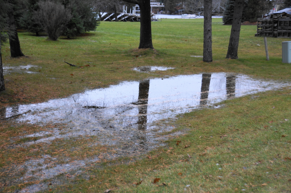 The lake is an inch or two from the July high. The ground around the lake is saturated and small (and some not so small) ponds are claiming lawns.