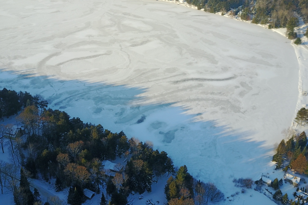 On Saturday, December 8th the drone was sent up to check for ice-in. We especially like the piney shadow "teeth" the morning sun gives the East shore.
