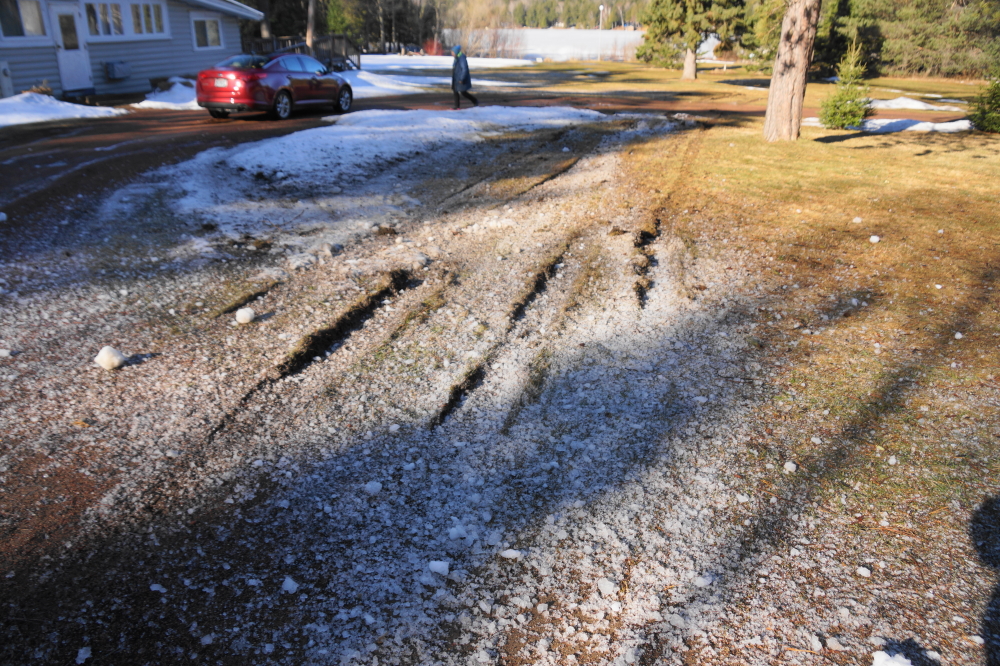 Sometime in the wee hours on Friday, someone missed the turn in the corner of the lake, hit the still impressive snow piles, went airborne over the bar's driveway, landed and skidded to a lawn ripping halt 200 feet later, then rutted another 100 feet of lawn back to the road. We slept through the entire affair.