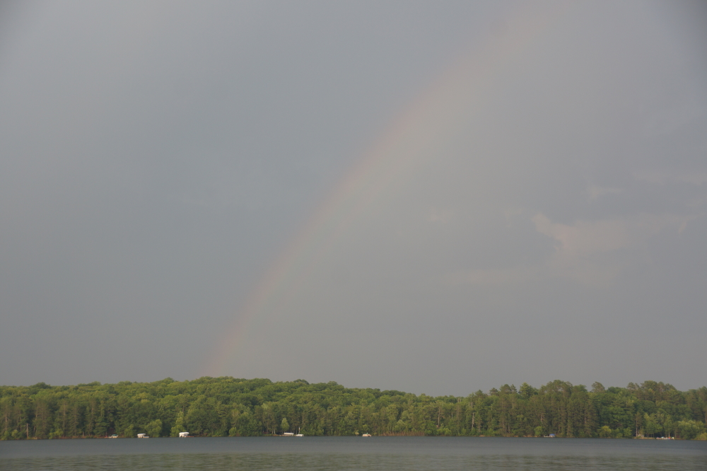 While the dropped skis were gathered and feet were cooling off, a huge storm parked itself over Lake Wabikon to the East of Lake Lucerne. No rain made it to the crowd, but right before the second act, lightning struck just off the shore about 500 feet from the crowd. It was much closer to one of the tow boats. The boat was fine, the driver may have a little hearing loss, and the observer got a little singed. The powers that be voted to delay the show for 30 minutes. The lightning and thunder did not stop and the show was delayed until next Monday.