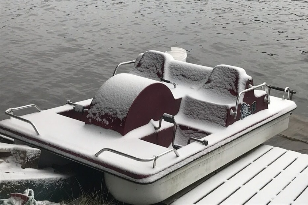 On the shore of Lucerne, a dusting of white has given items (boats, docks, rafts, swimmers) a Christmas-y feel.