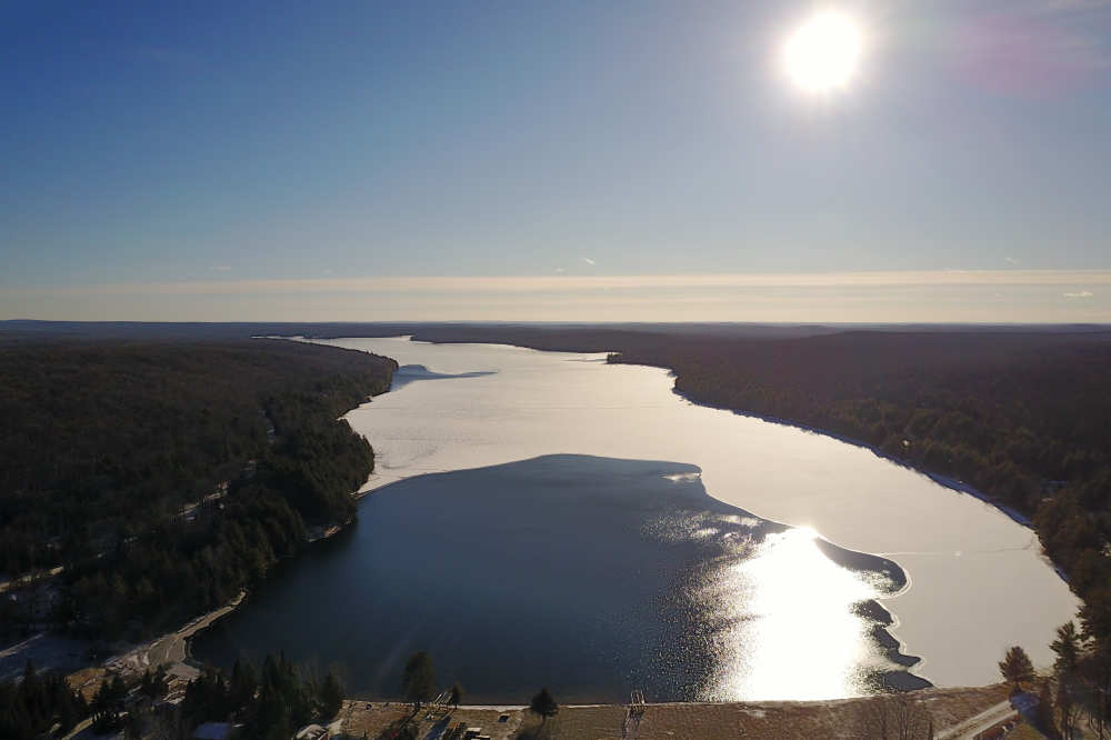 Last week the lake started with some ice, some open water, and no skiers.  A dusting of snow improved the contrast between the open and the ice. The thin, white blanket also made it clear that the ice was winning the battle for the soul of the lake and that Fall was a distant memory.