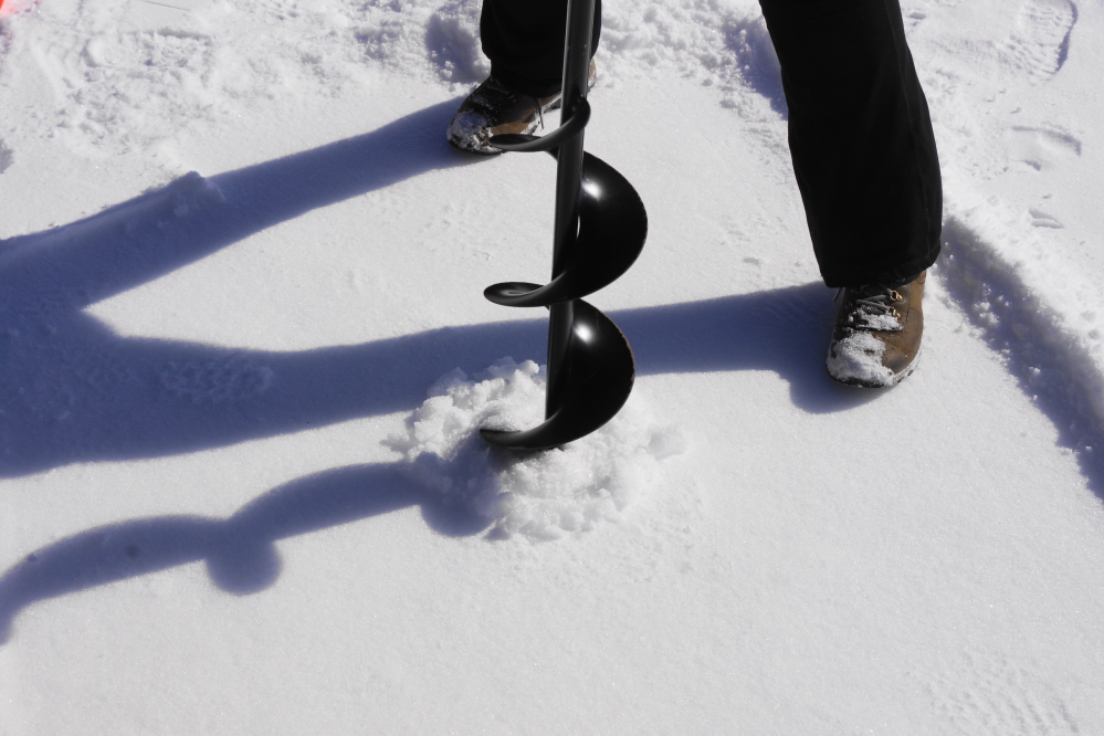 On Sunday, under the watchful eyes of a waiting around Zombie Winter, we cut a hole in the lake ice to check its thickness.