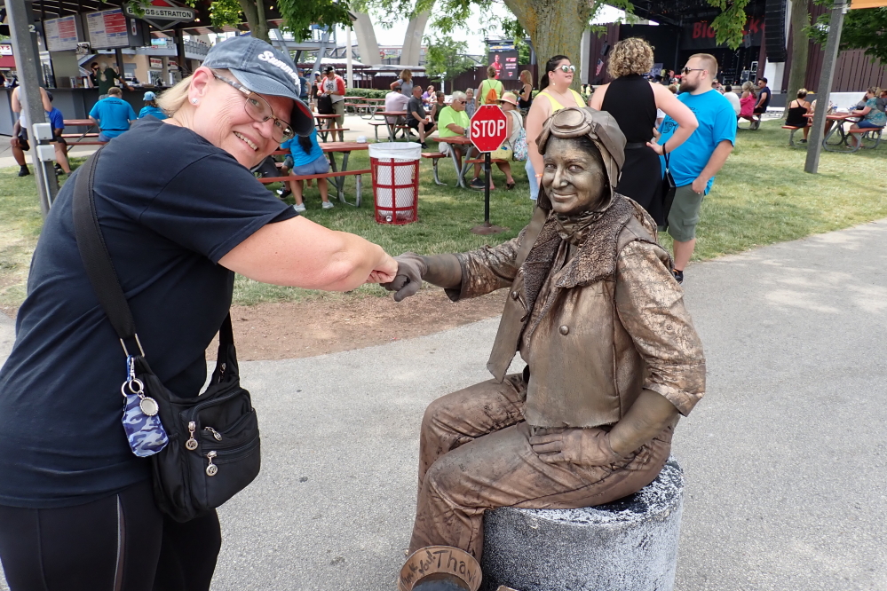 The festiveness of music and deep fried food was augmented by a fist bump from a living statue.