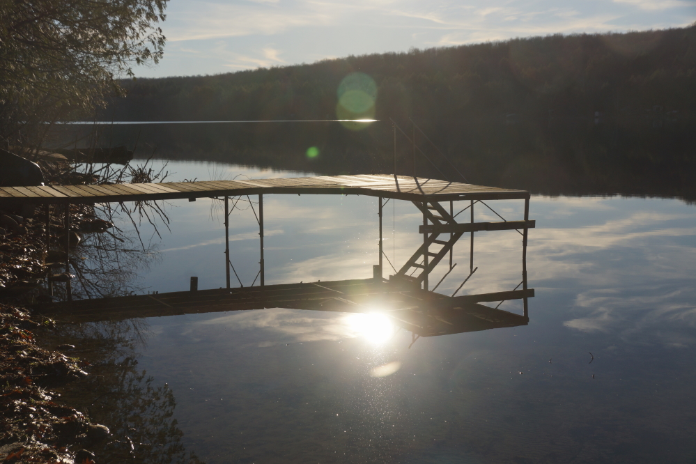 After the rain, the lake flattened out. With no ski boat in, the men decided to take advantage of the stillness and pull the last of the piers from the icy water.