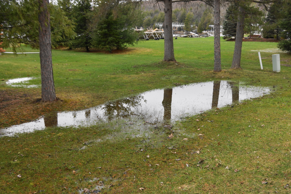 The numerous lawn puddles around the lake grew from large to navigable.