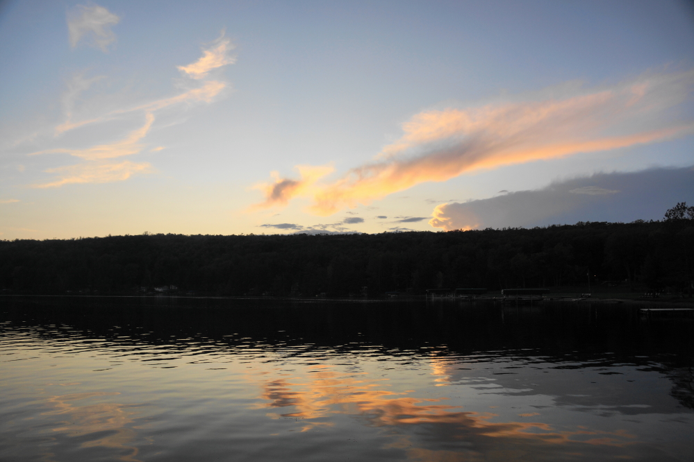 As the end of Sunday approached, the sky cleared more and the lake became flatter.