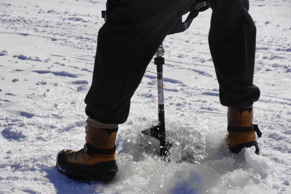 During the dance of the devils, a few of the men were tasked with checking Eurasian Milfoil under the ice in front of Water's Edge. An electric power auger made drilling a hole super easy, barely an inconvenience.