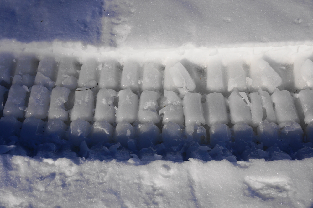 The warm on Friday (48°F!) slushified the lake snow. Then the cold came back. Friday's snow tracks froze. The lake became hard, cold, and lumpy.