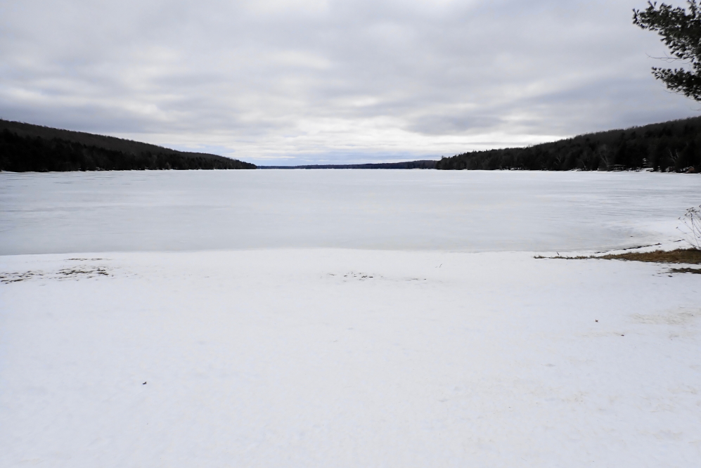 Judging from the looks of things, the lake level is low compared to last year. Lucerne really needed this past snow to hold its current level and needs a wet April to get back to last year's springtime peak. With the cold nights we've been enjoying, a March Ice-Out is not impossible, but is becoming less and less likely. Nine inches a week is the fastest ice burn off rate we've seen. That would put Ice-Out just after Easter. The only thing we can say for sure about Ice-Out 2026 is that if you don't enter this year's <a href='/iceout/IceOut2026.html' class ='defaultlink2' target='_blank'>Annual Knottlane Ice-Out Contest</a> you will not win.<br><br><br>-Nemo shovels decks and drills iceholes instead of jogging.