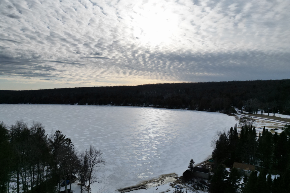 The wind blew most of the new snow off the lake. 