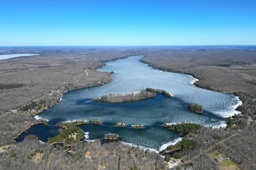 By the middle of the week, rain and a new warmth began to take a toll on the lake ice. It was still there, but darker and thinner.
