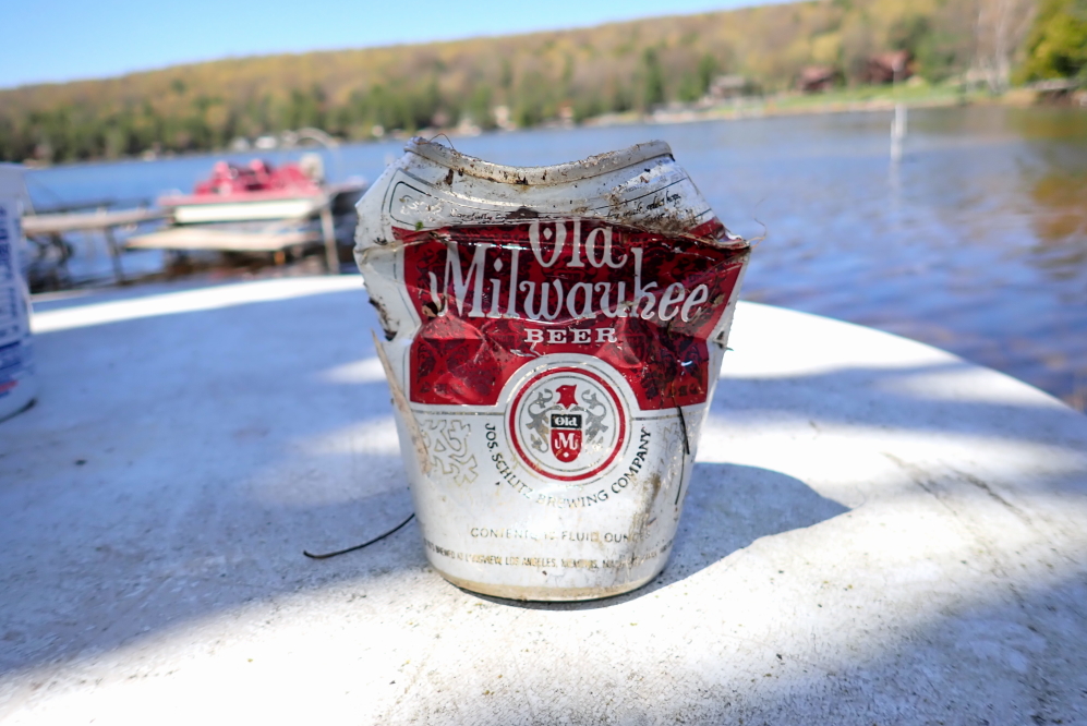 While pulling the tree from the freezing water, we saw part of a silvery top in the shallows. It turned out to be an old beer can.
